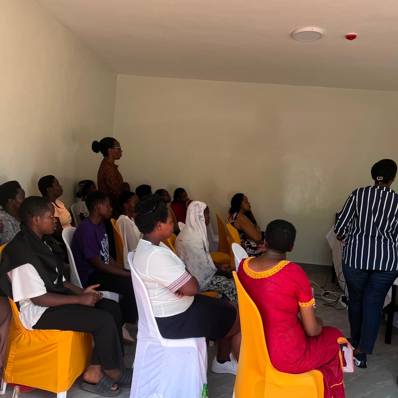Trainees listening attentively during the caregiver training session